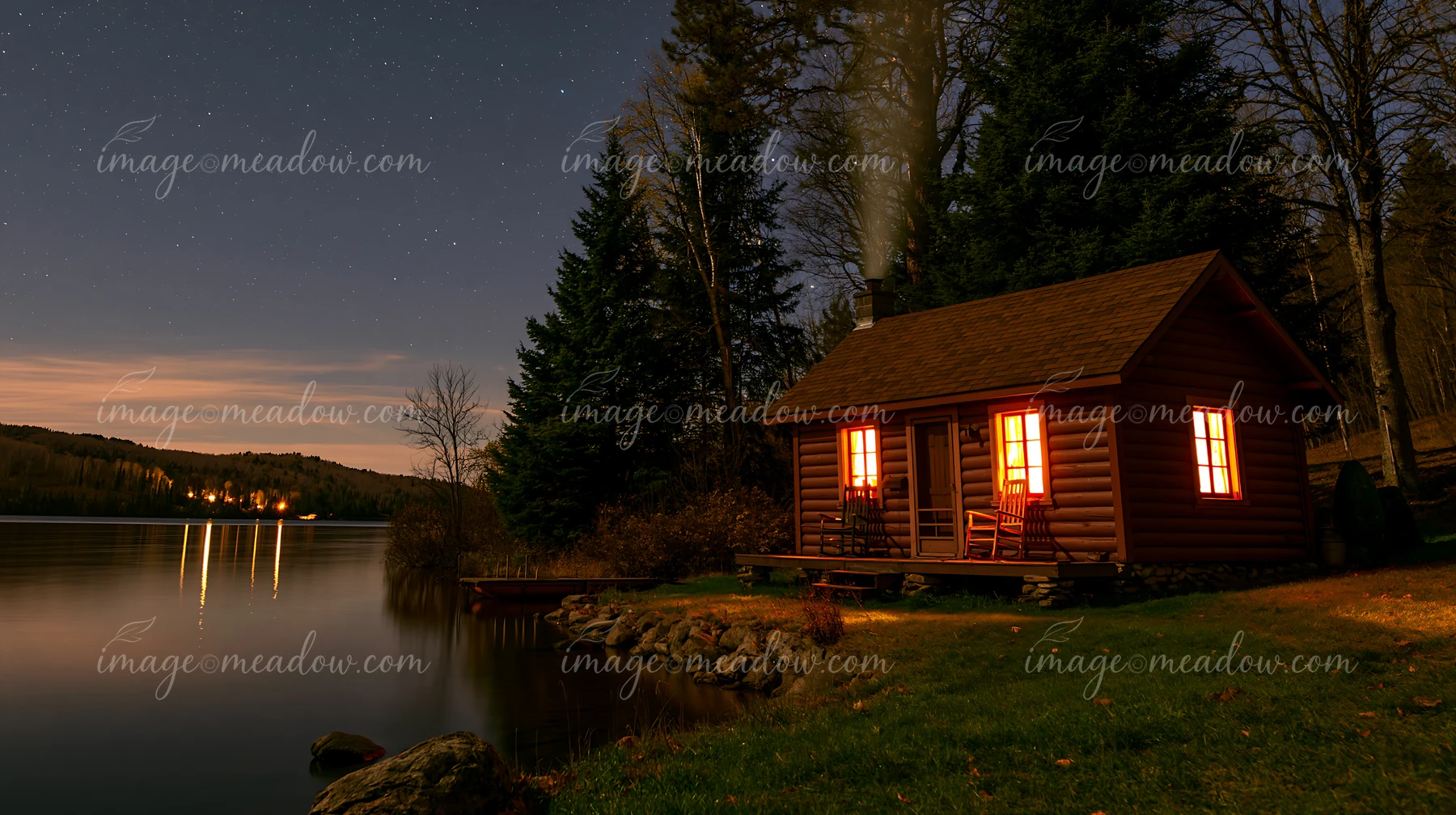 A cozy cabin sits by the water with smoke rising from its chimney under a clear starry sky.