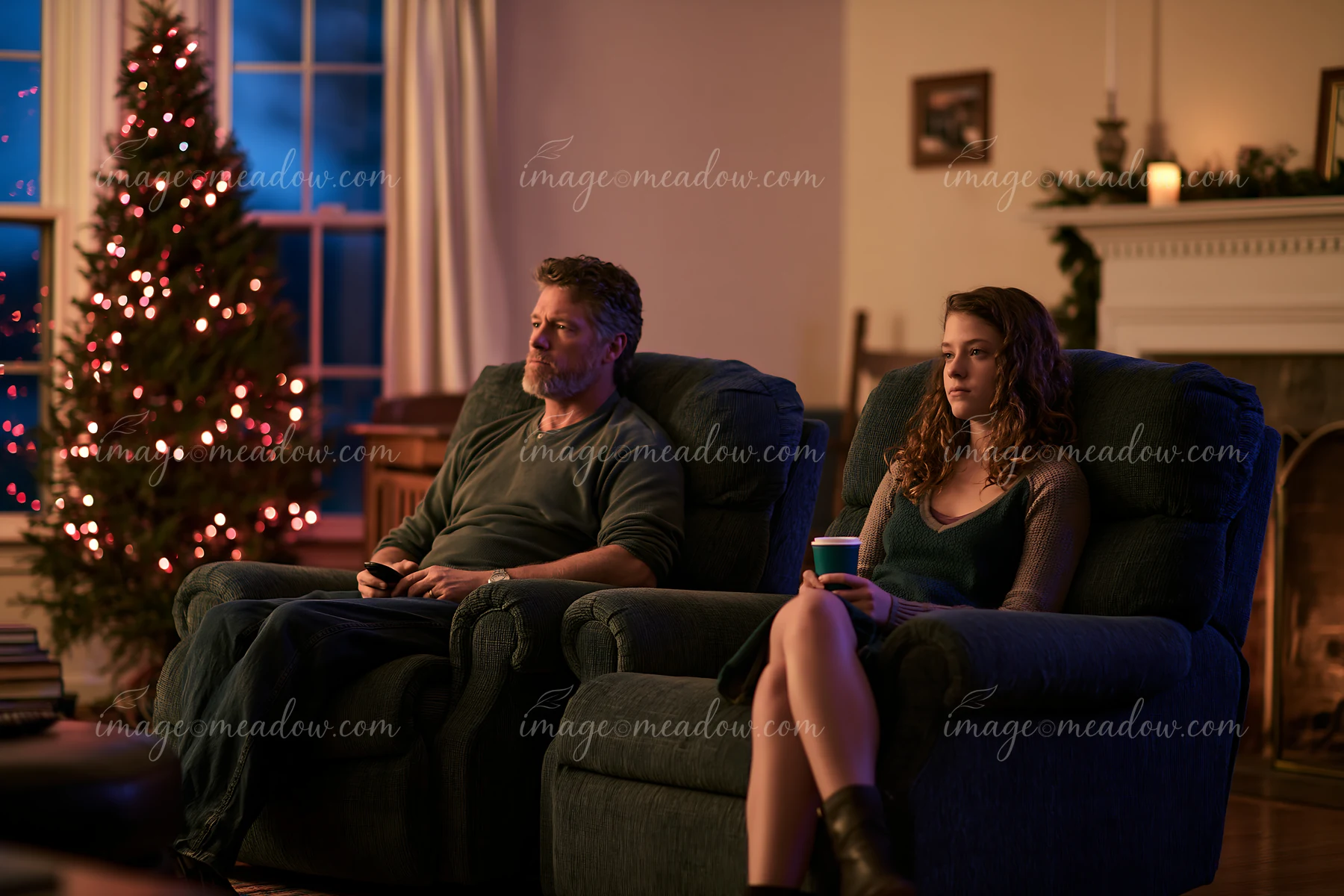 A family relaxes in their living room while watching a holiday movie.