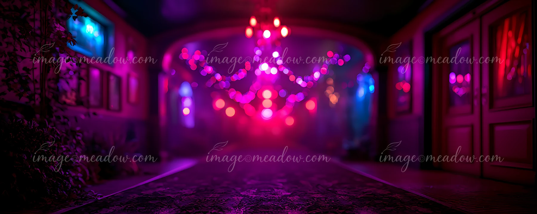 A hallway is filled with colorful lights hanging from the ceiling.