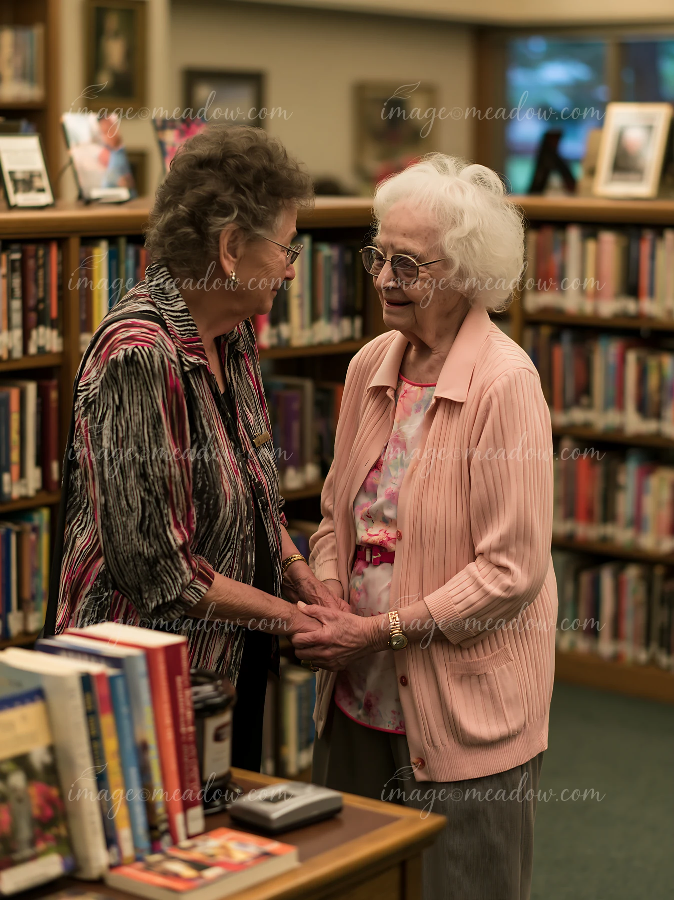 A person with Alzheimer's recognizing a familiar family member shares a warm moment in a library filled with books.