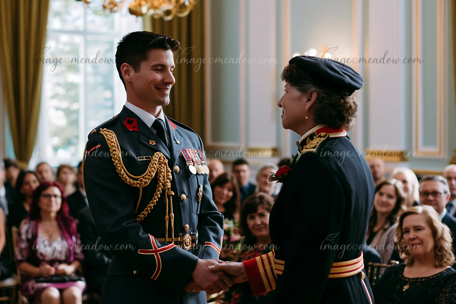 A soldier receiving medal stands in front of an audience at an official ceremony.