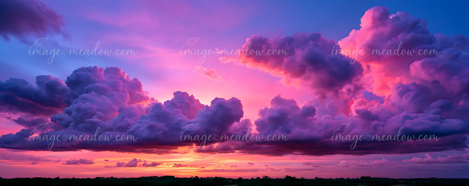 A sunset displays colorful clouds in shades of purple and pink, casting a glow over the landscape.