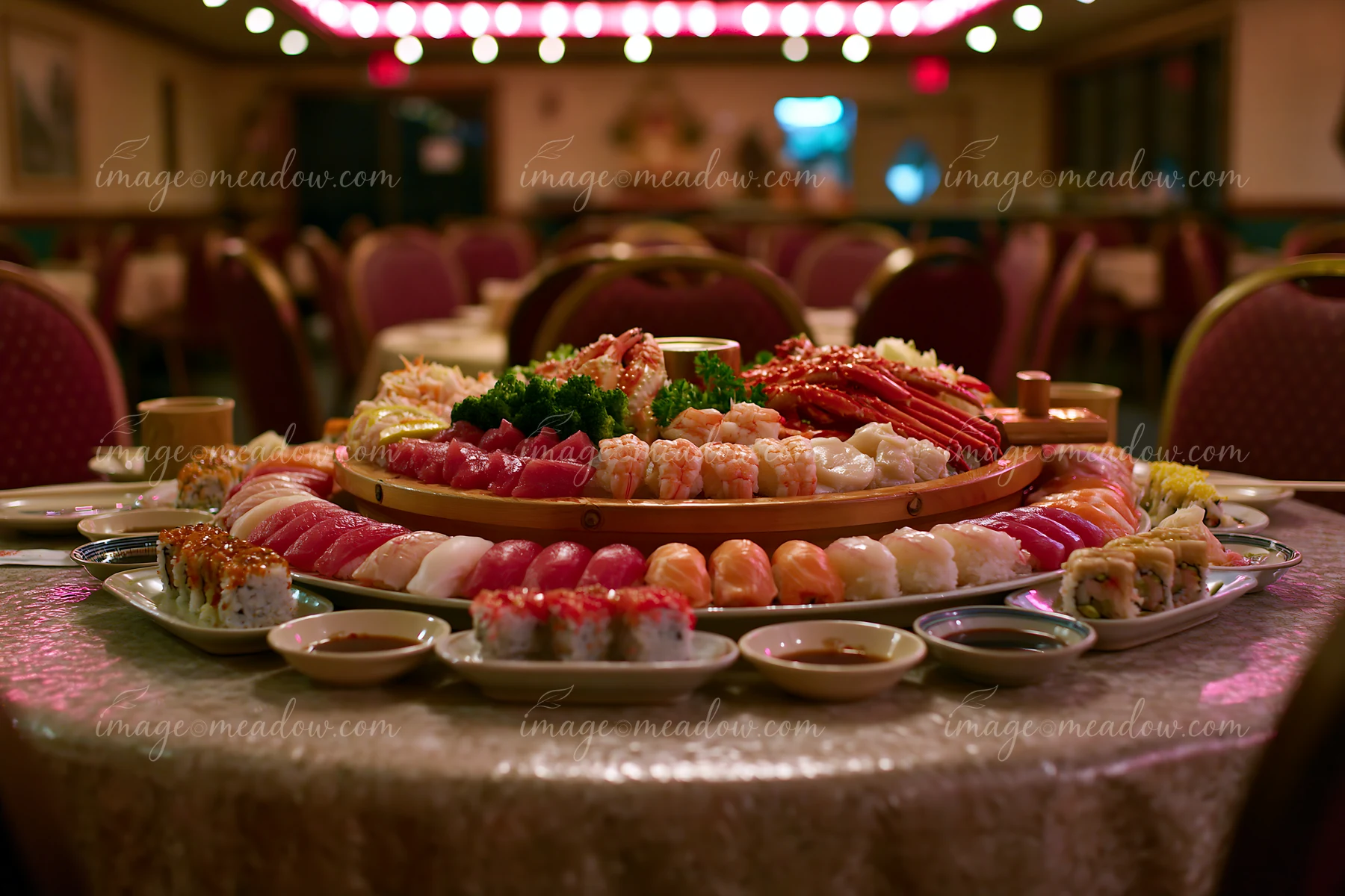A sushi boat with assorted seafood is displayed on a table in a restaurant.