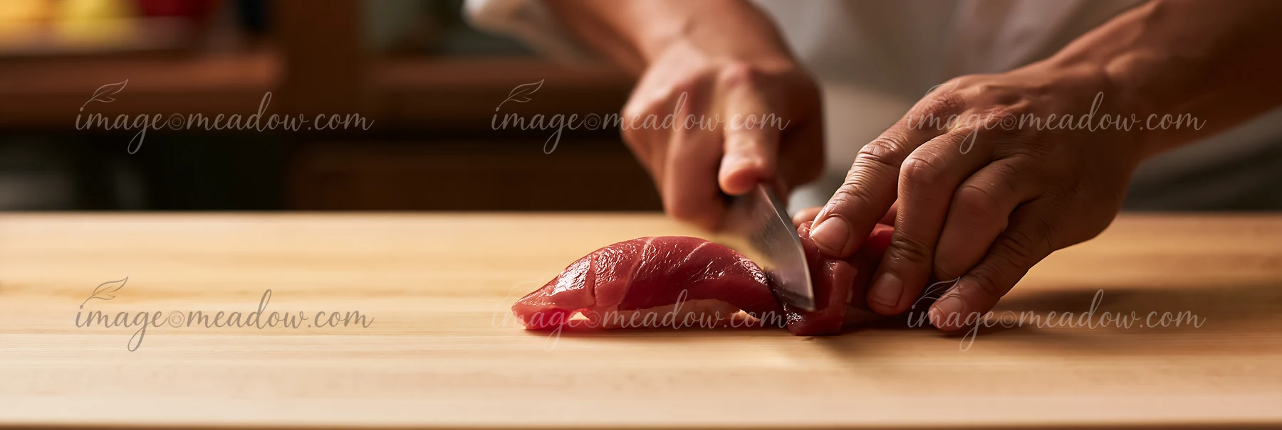 A sushi chef skillfully cuts fresh fish on a wooden board in a traditional kitchen.