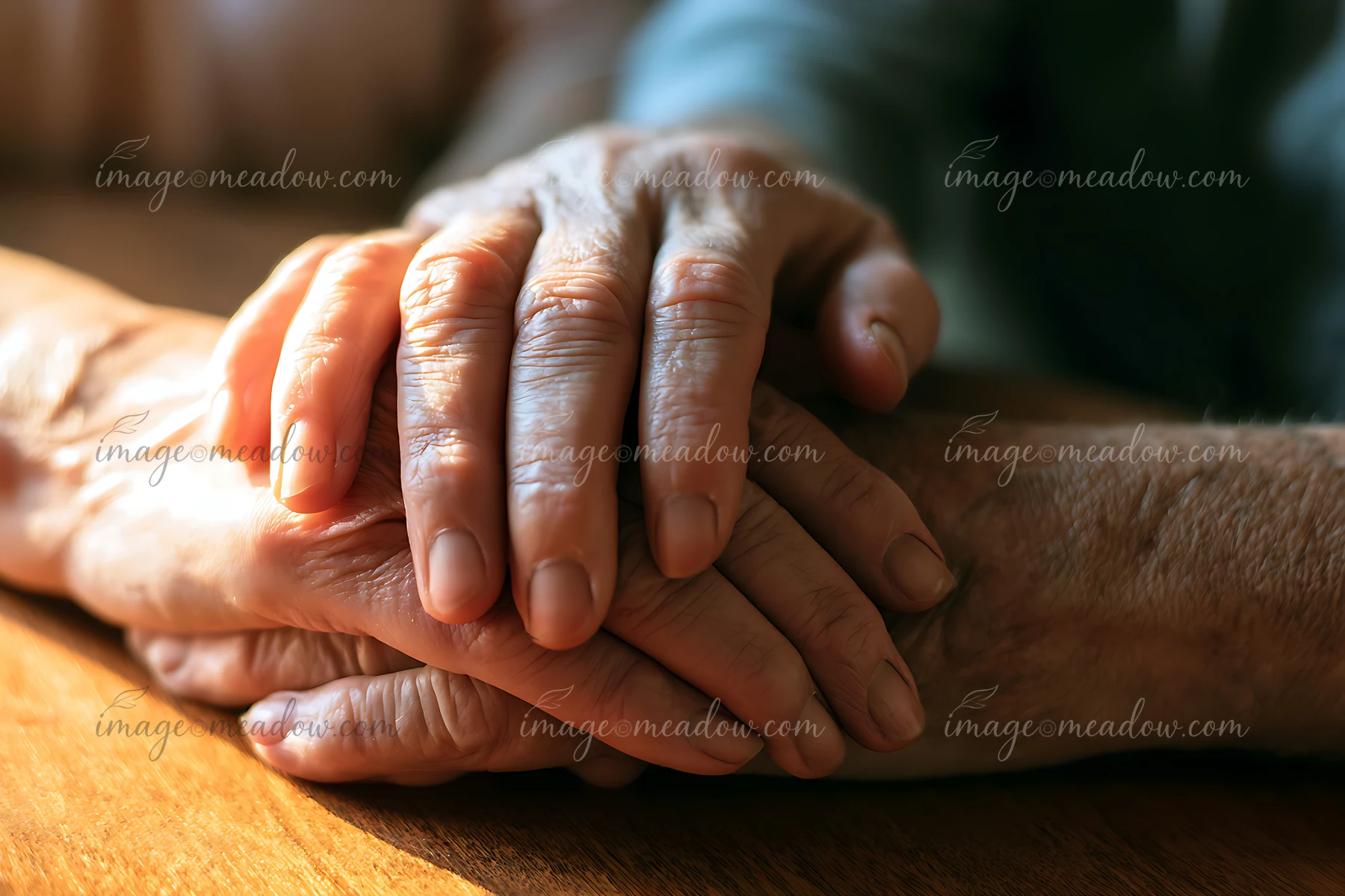 Two hands are intertwined on a table during a hospice visit, showing connection and support.