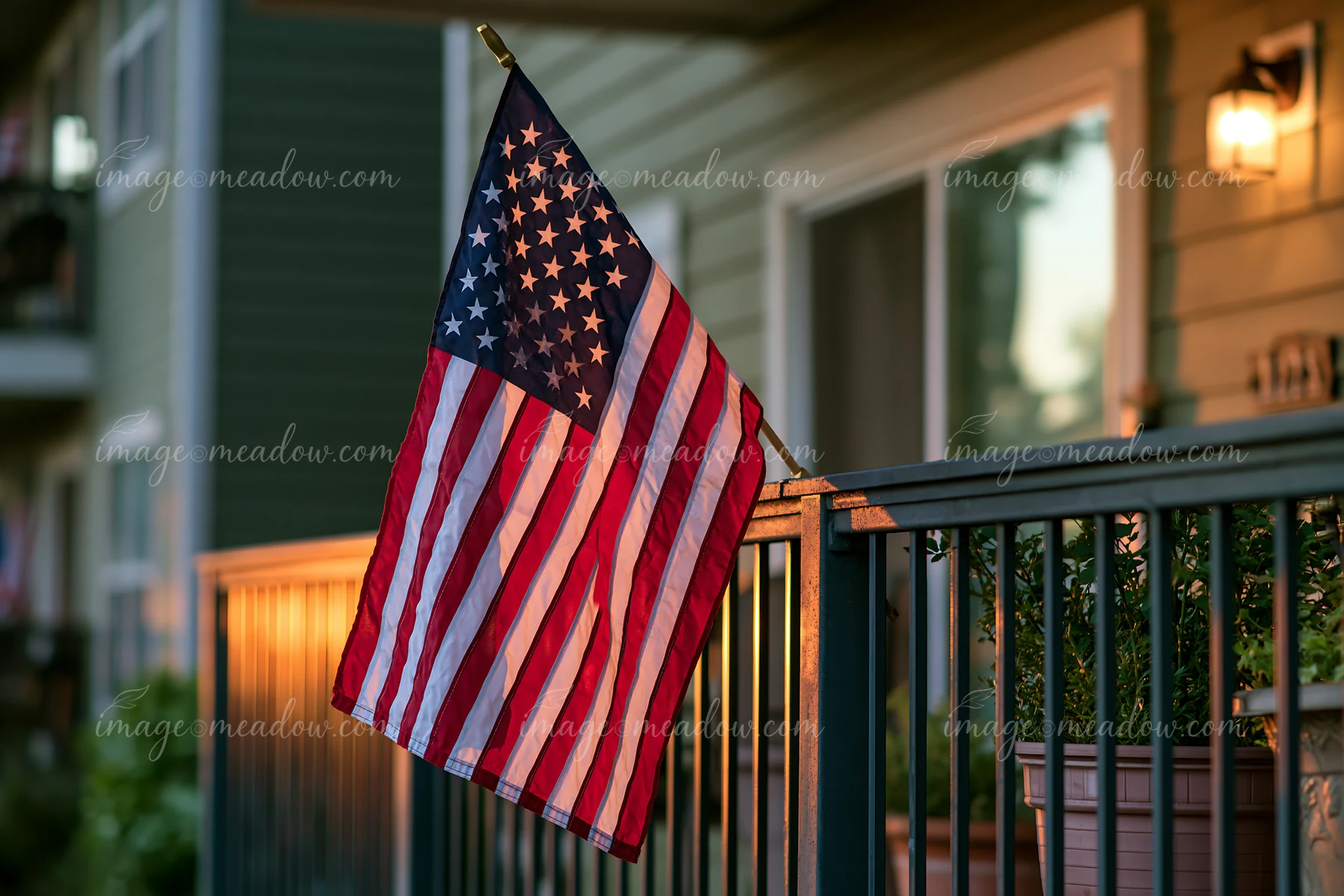 A bright American flag outside an apartment building shows national pride.