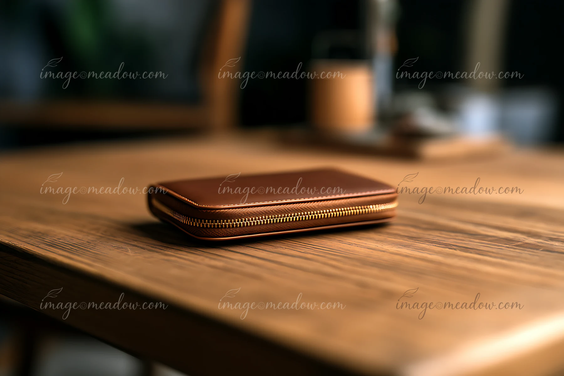 A brown wallet rests on a wooden table in a cozy setting.