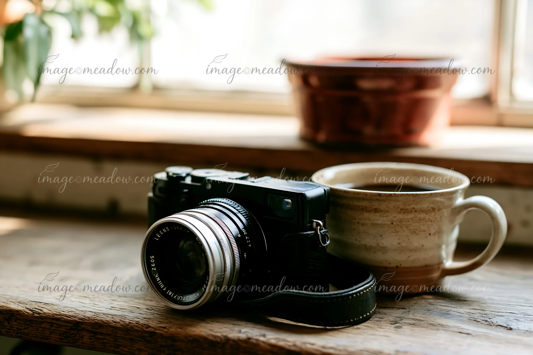 A camera and lens on a wooden shelf next to a coffee cup, with natural light coming in through a nearby window.