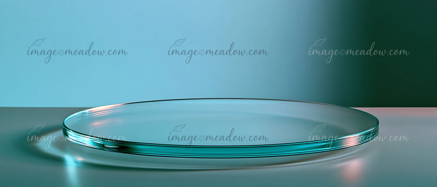 A clear glass plate rests on a smooth surface, reflecting light against a soft blue background.