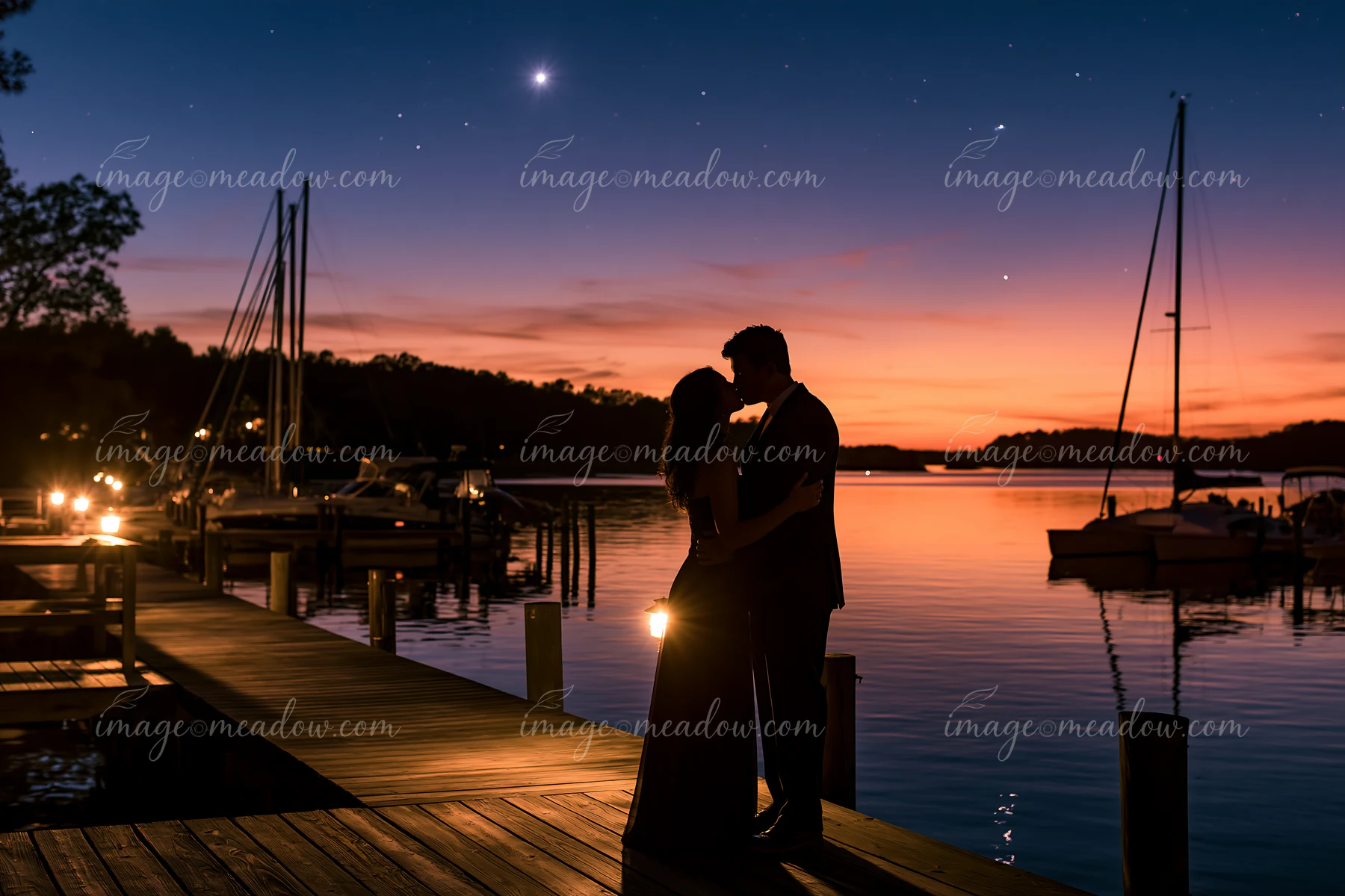 A couple kissing on a dock under stars at sunset.