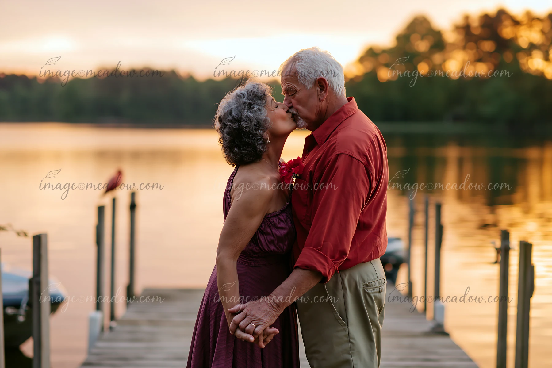 A couple stands on a dock by a lake, sharing a kiss that symbolizes lasting relationship.