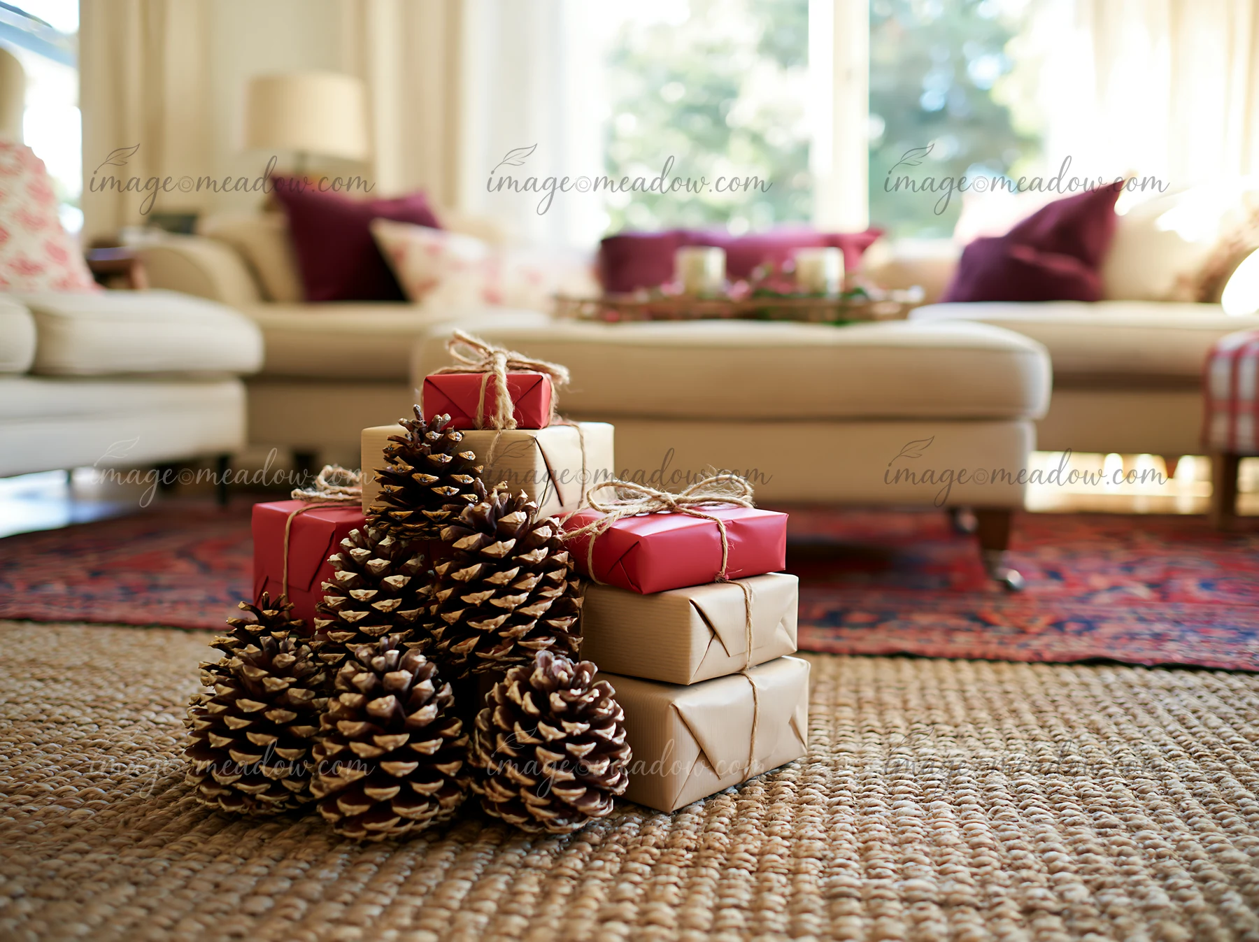 A cozy living room features wrapped gifts stacked near pine cones on a woven rug.