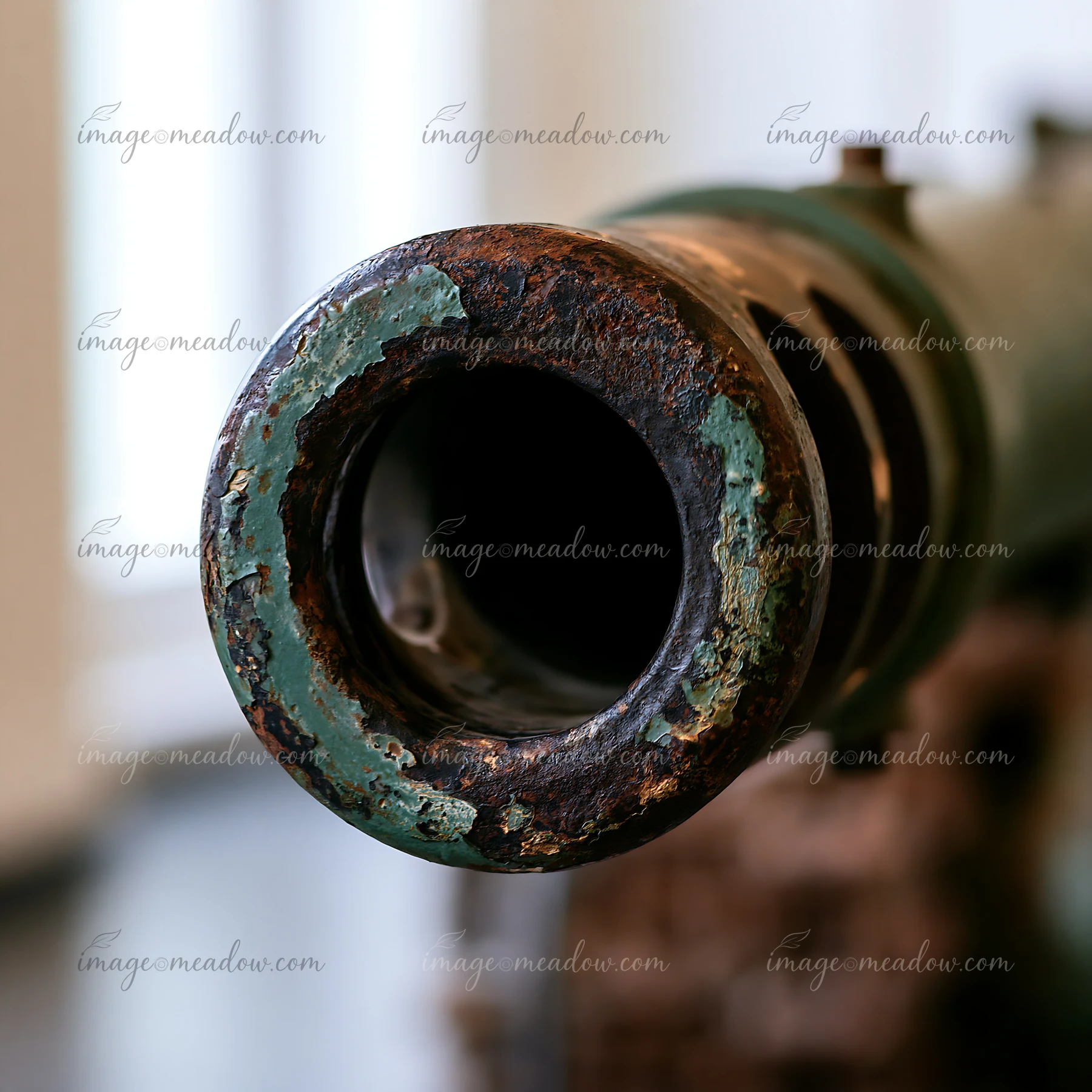 A detailed focus on the end of a panzer tank gun barrel shows wear and texture from use.