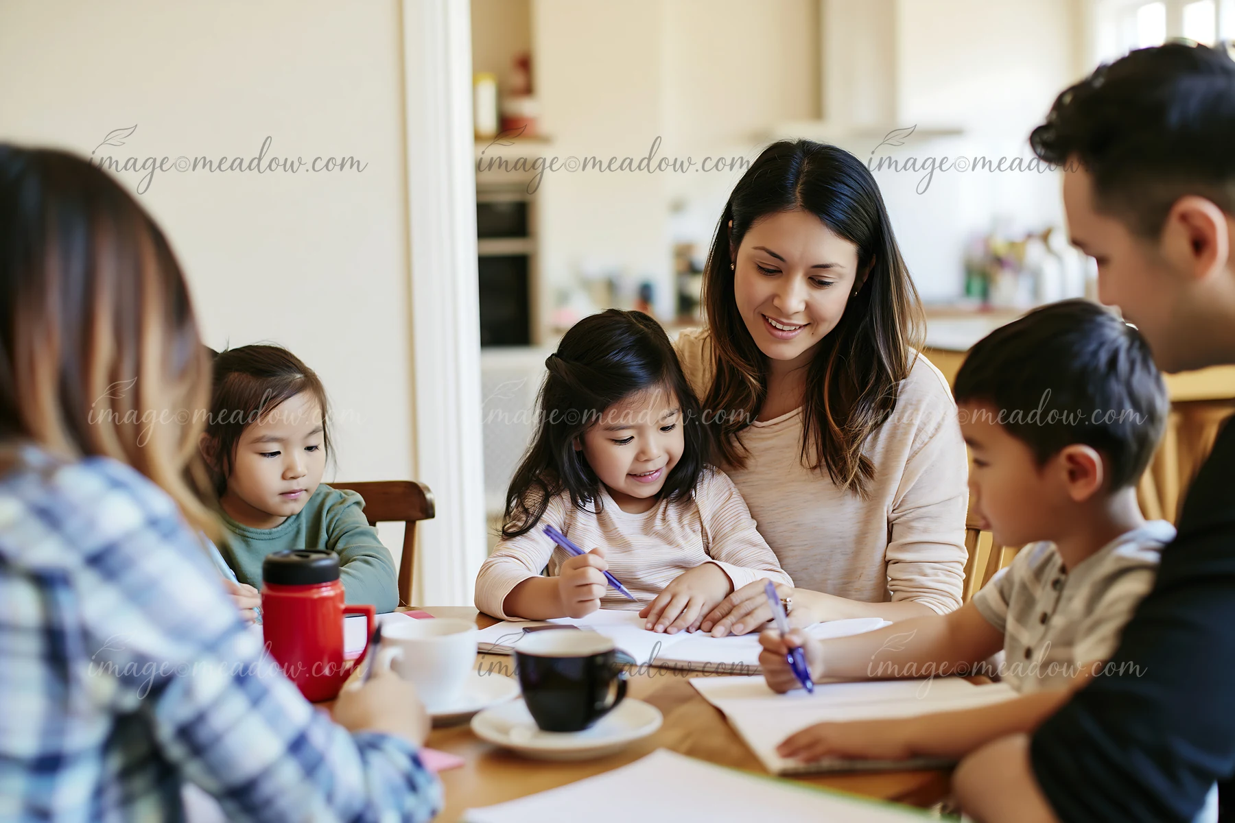 A family sits around a table in a cozy kitchen, engaging in a fun activity.