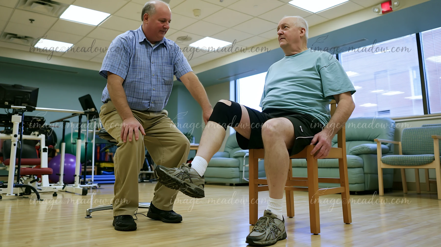 A healthcare professional assists a person with Parkinson's disease receiving support in a rehabilitation center.