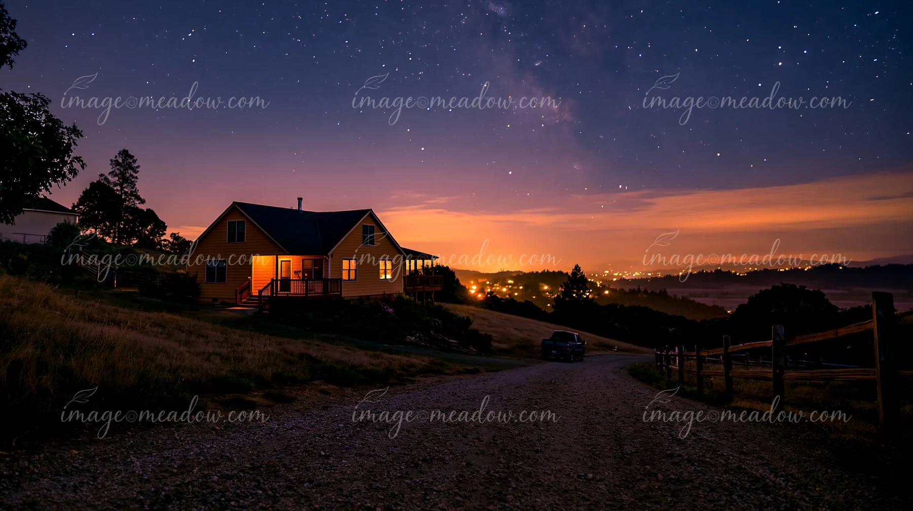 A house stands on a hillside under a clear starry sky.