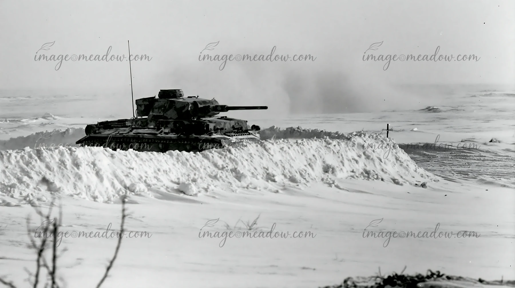 A panzer tank in winter snow moves across a snow-covered landscape.