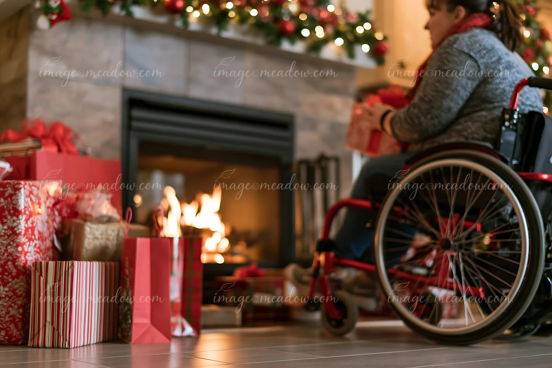 A person in a wheelchair sits beside a warm fireplace surrounded by colorful holiday shopping bags and presents.