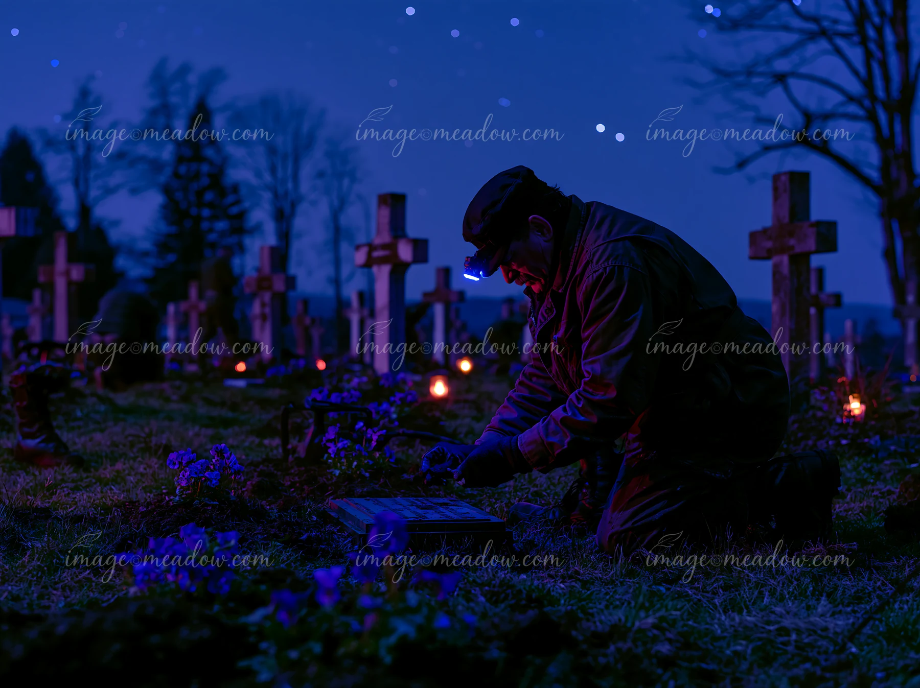 A person kneels in a soldiers' cemetery under a starry night, tending to a grave.