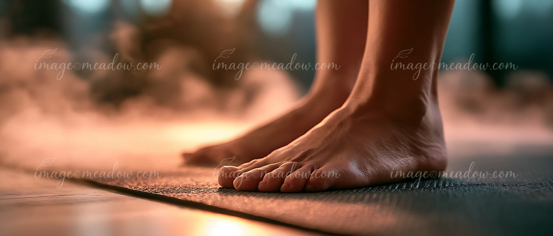 A person stands on a yoga mat in a room with soft lighting and gentle mist.