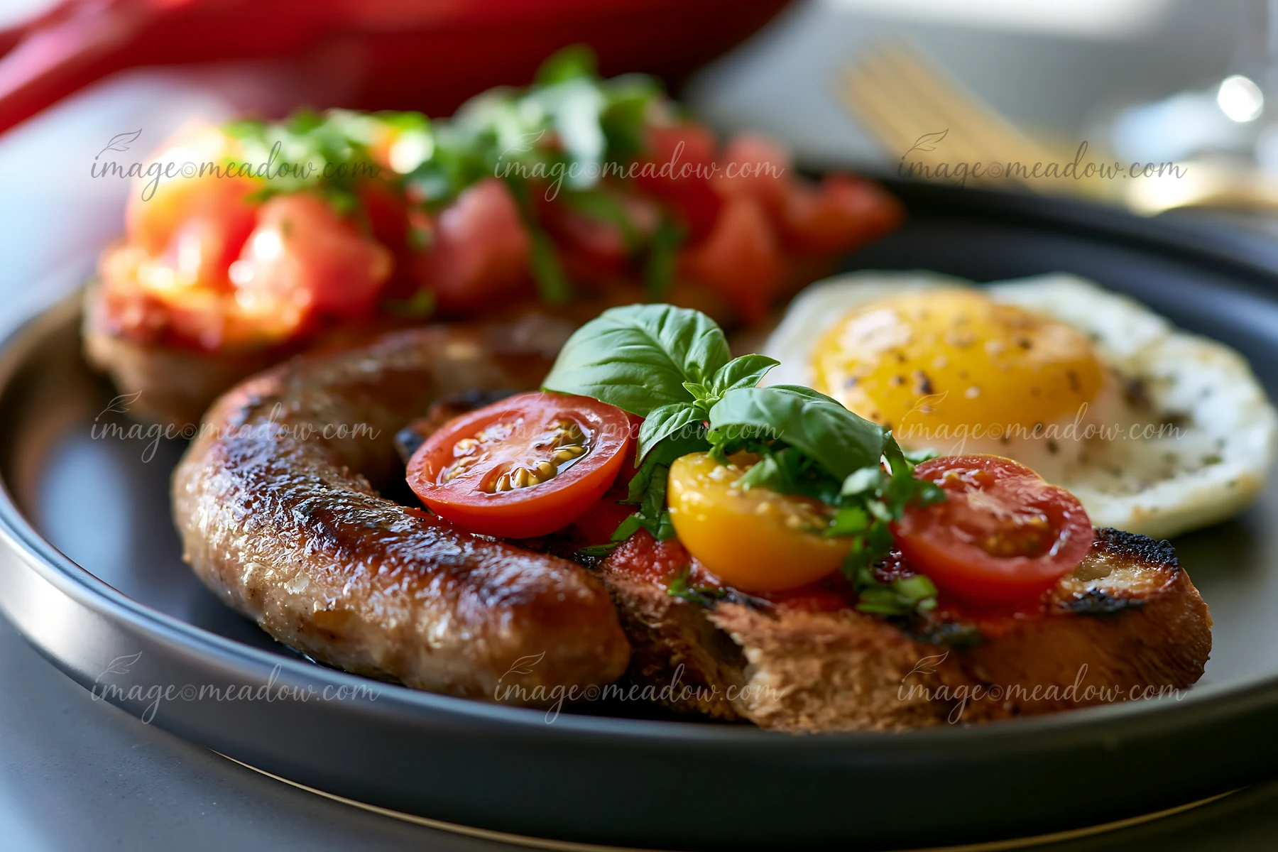 A plate features grilled sausage, tomatoes, and a sunny-side-up egg, showcasing sustainable buffet catering.