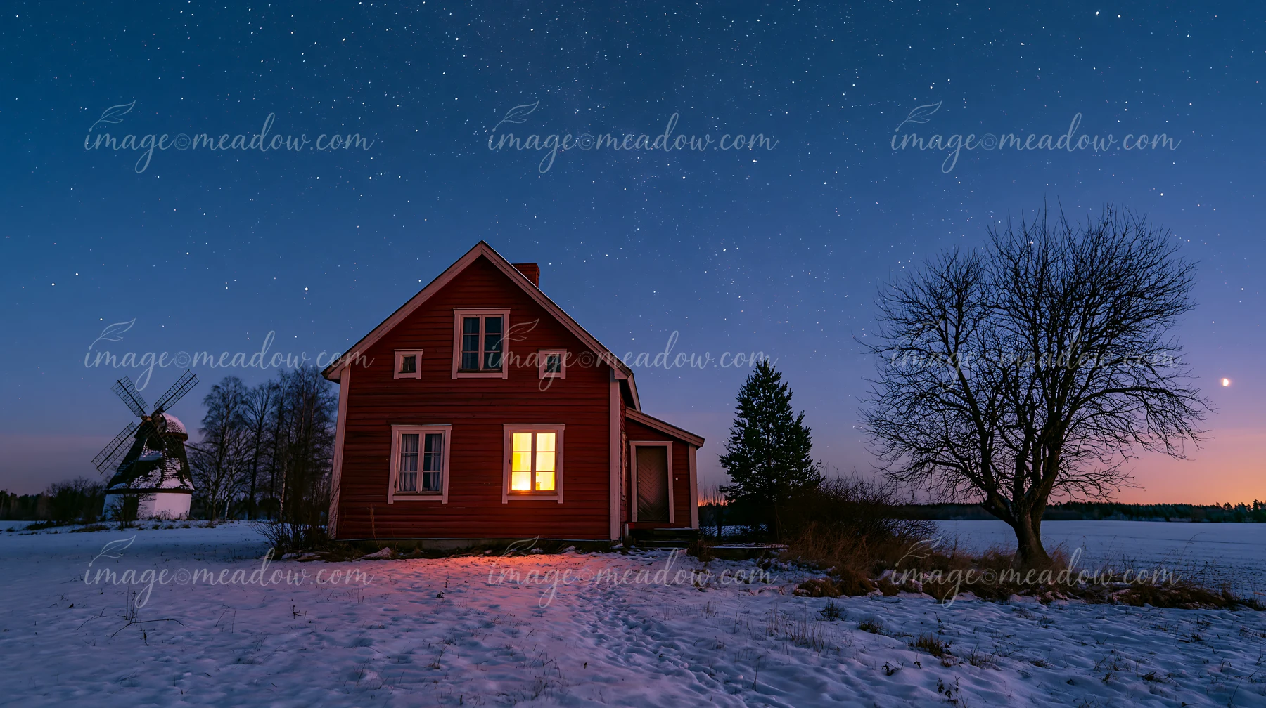 A red house sits in the snow with a warm light shining from the window.