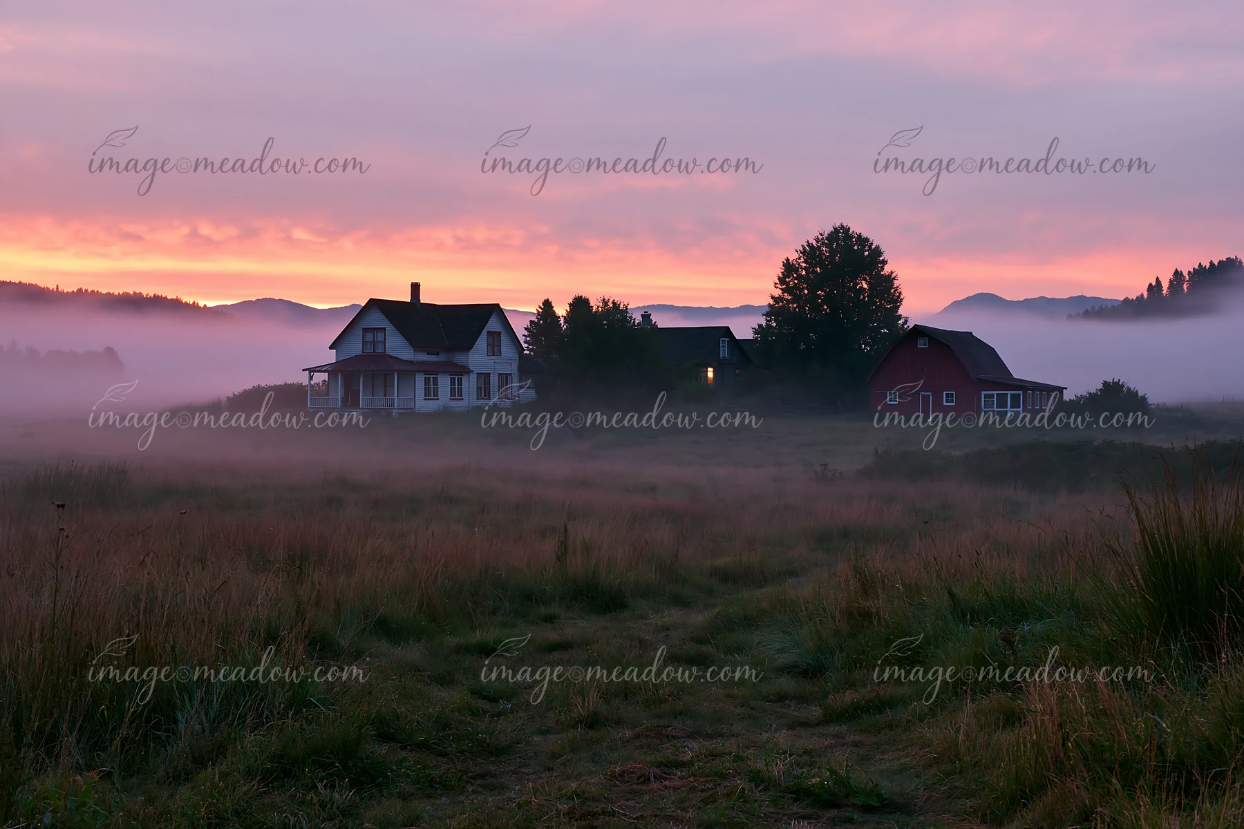 A rural farmhouse in morning fog is seen against a colorful sky.