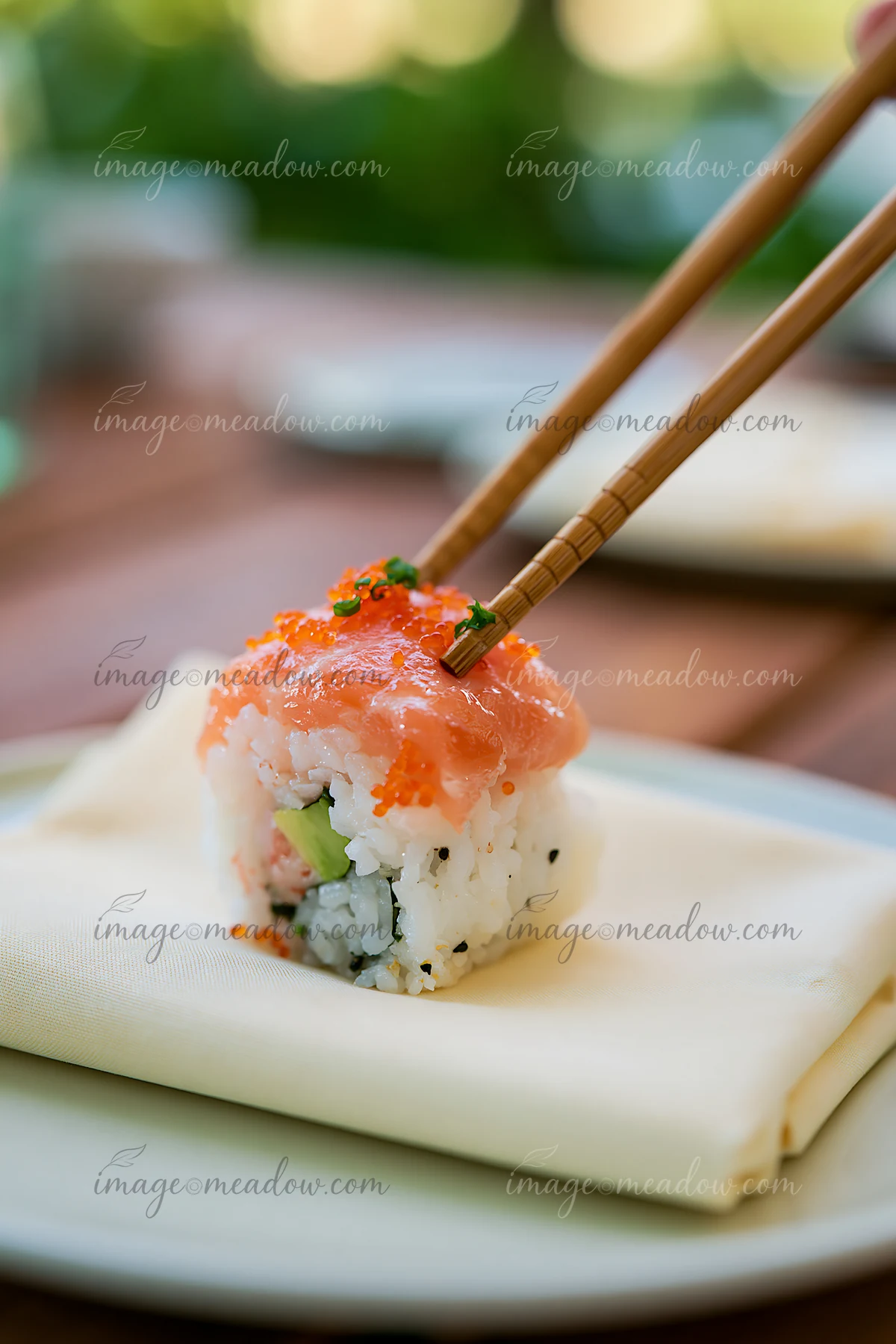 A single sushi piece with chopsticks is placed on a white plate, ready to be enjoyed.