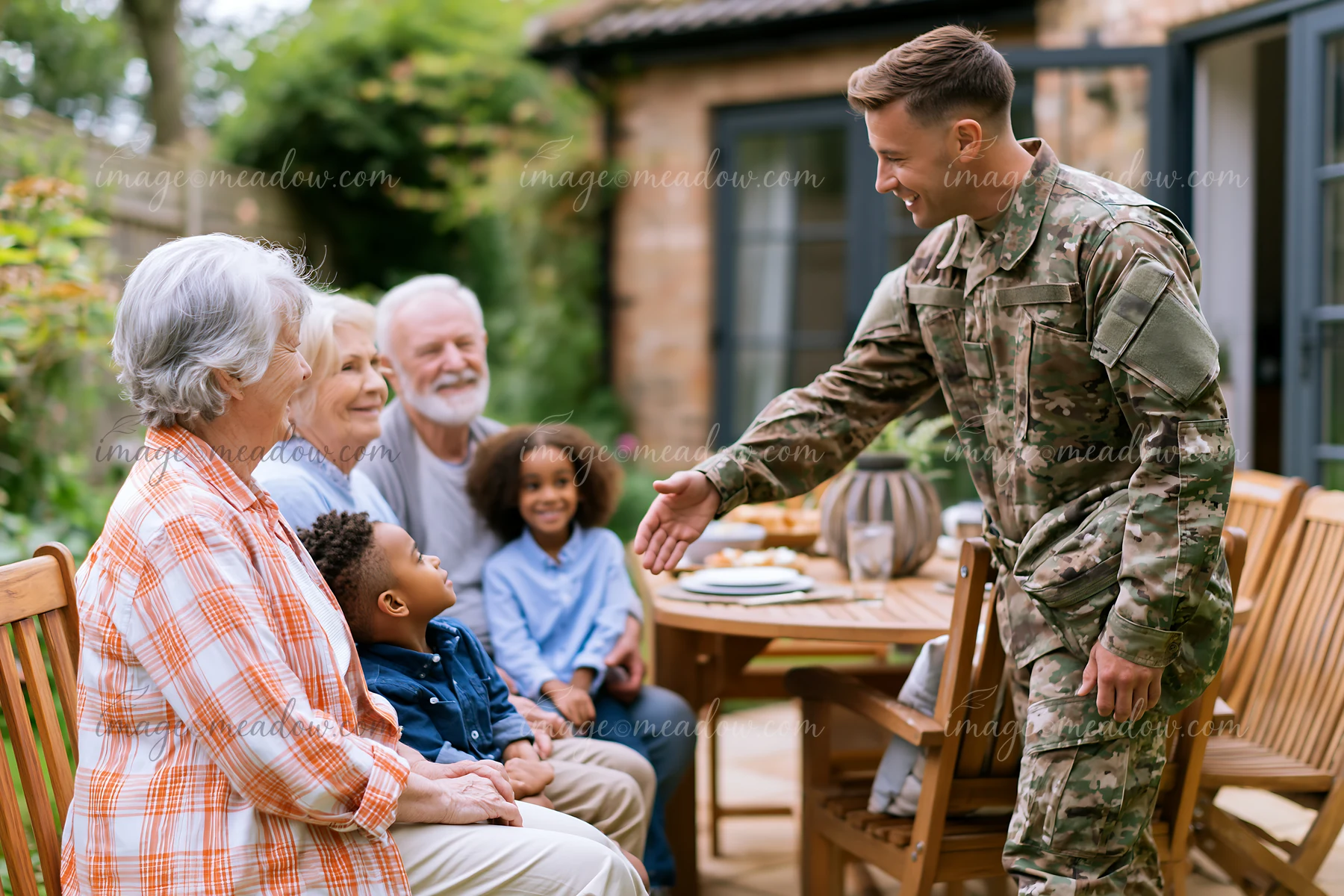 A soldier greeting family members in a garden setting.