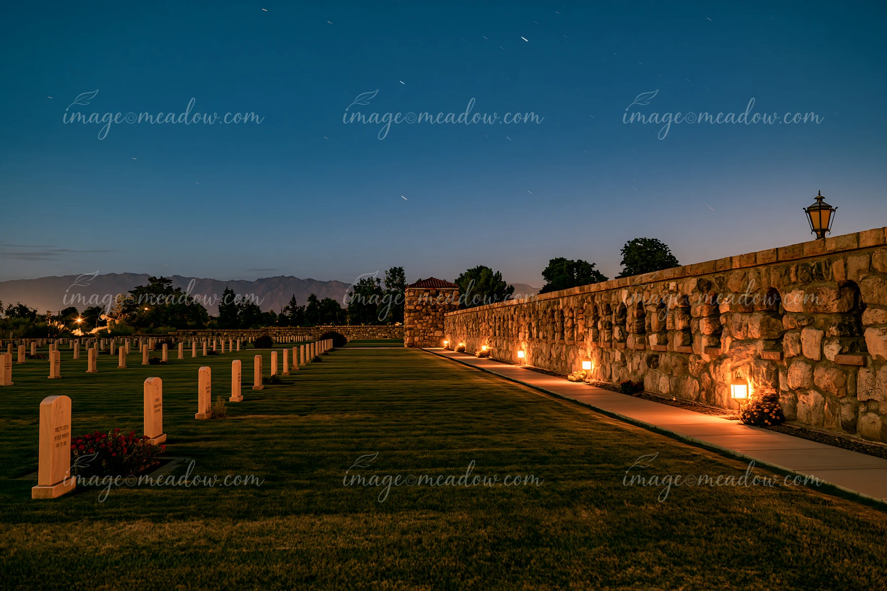 A soldiers' cemetery is seen under a starry sky filled with shooting stars.