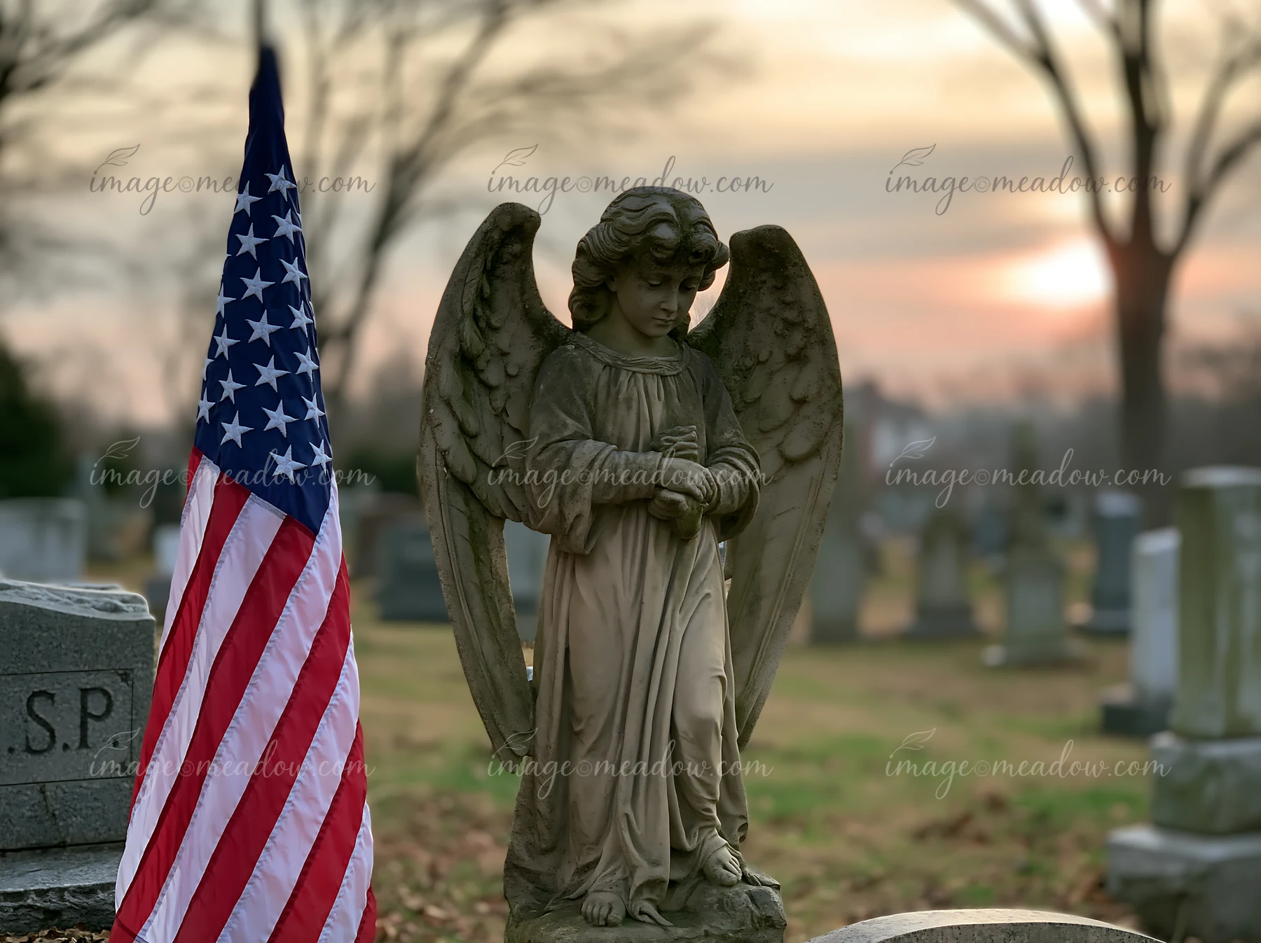 A solemn cemetery scene with American flag and stars features an angel statue standing amidst gravestones.