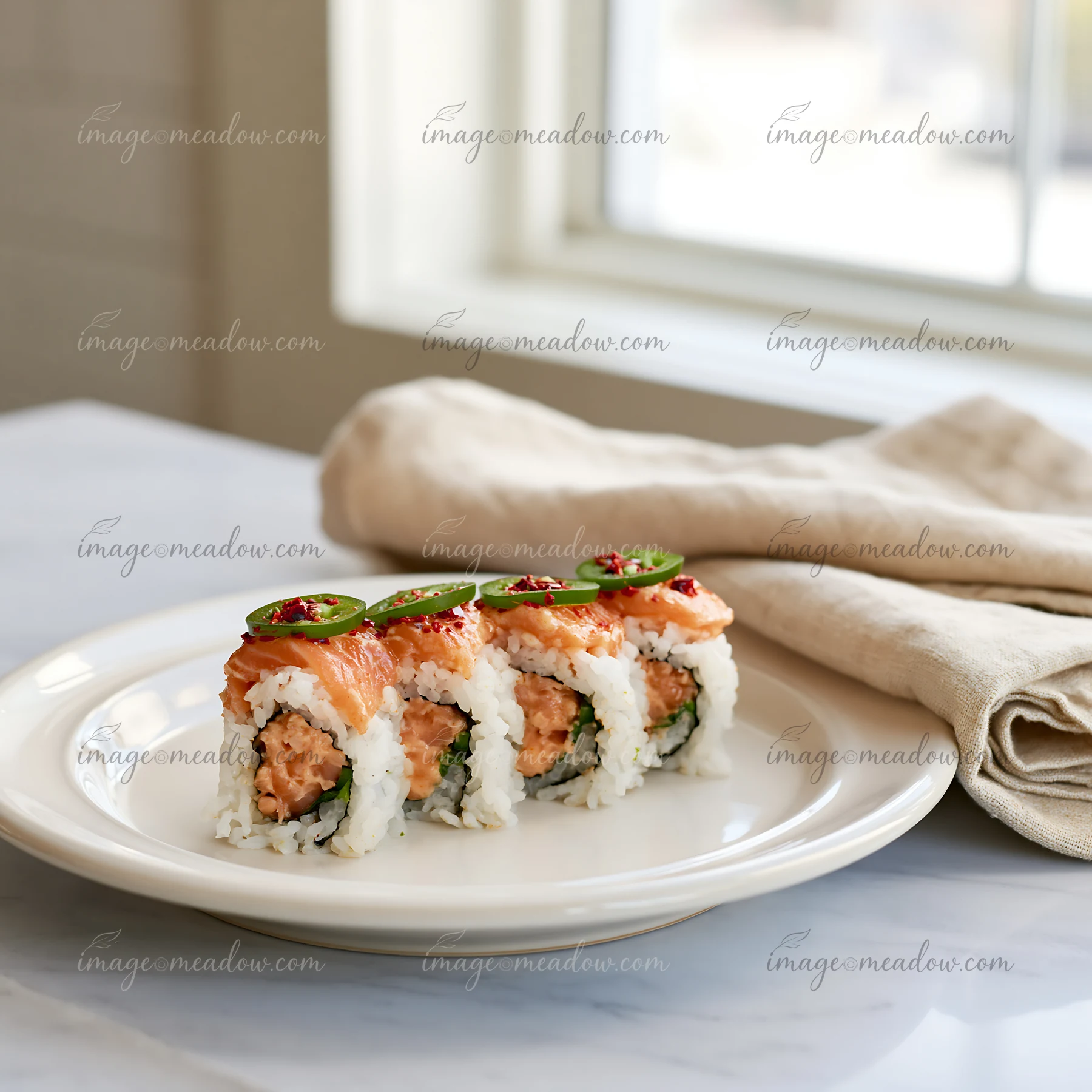 A spicy salmon sushi roll with chili is placed on a cream-colored plate.