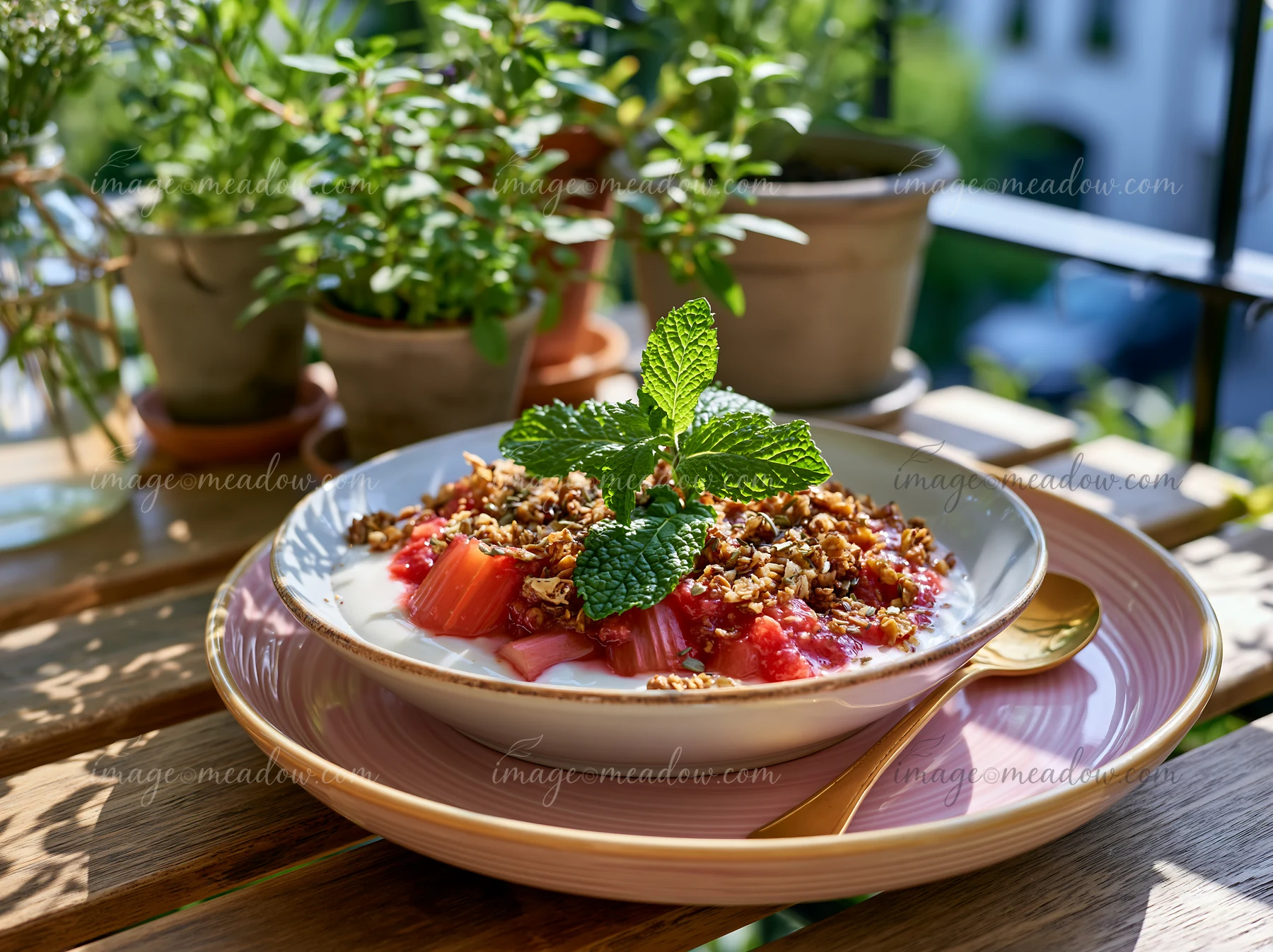 A spring breakfast plate features yogurt topped with granola and fresh fruit, displayed on a wooden table.