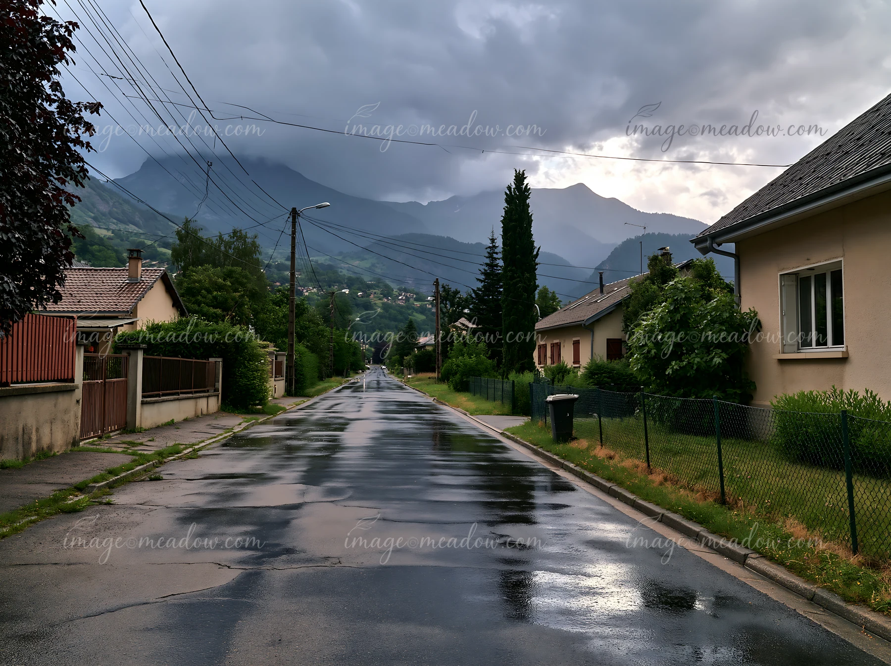 A storm moves over a mountain range, with dark clouds covering the sky.