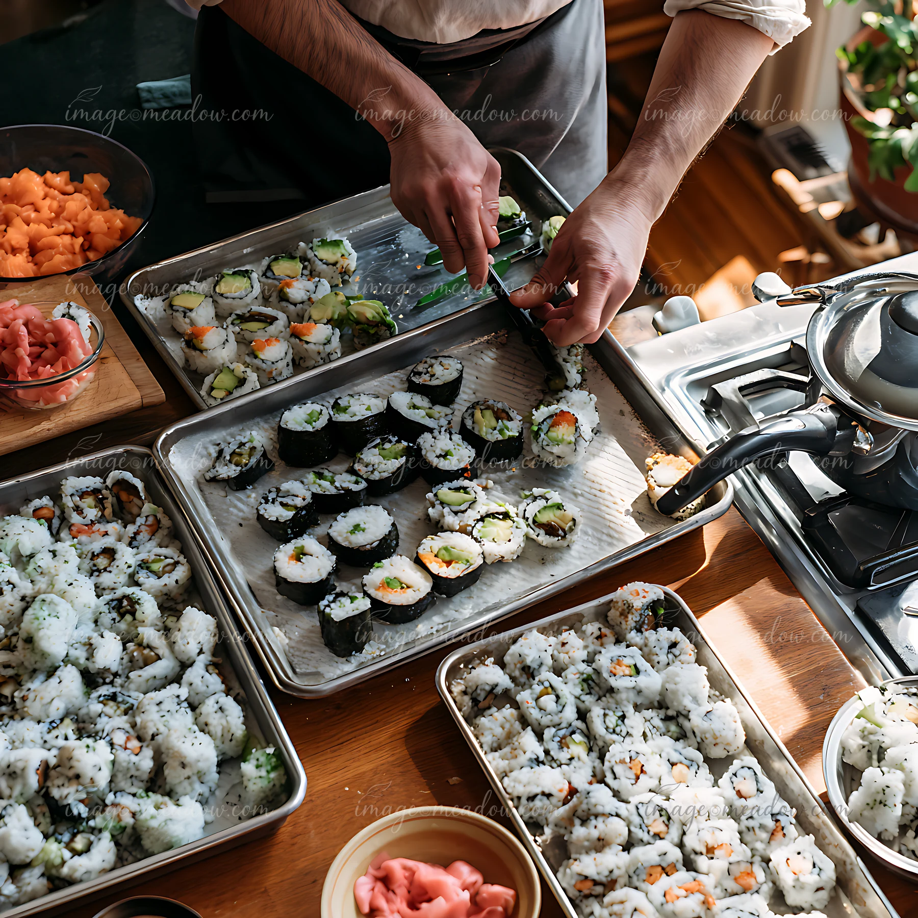A sushi chef prepares a sushi platter for a catering service in a bright kitchen.