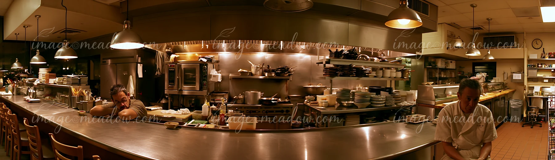 A sushi chef sits alone in an empty kitchen after service, reflecting on the day.