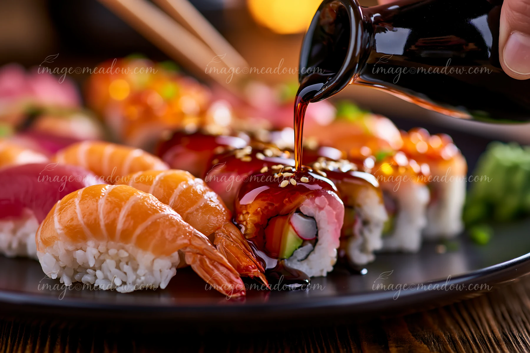 A variety of sushi is arranged on a dark moody table.