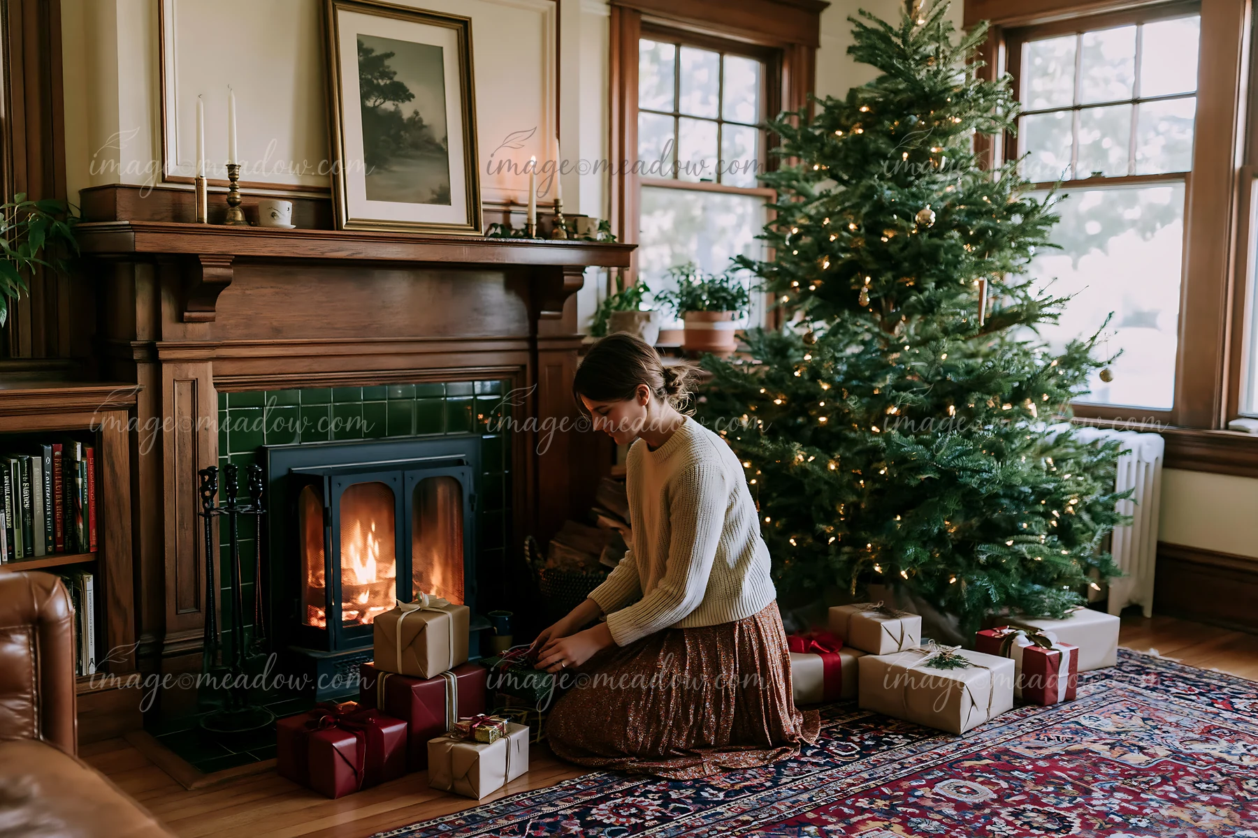 A woman sits near a wooden mantel in a Christmas living room.