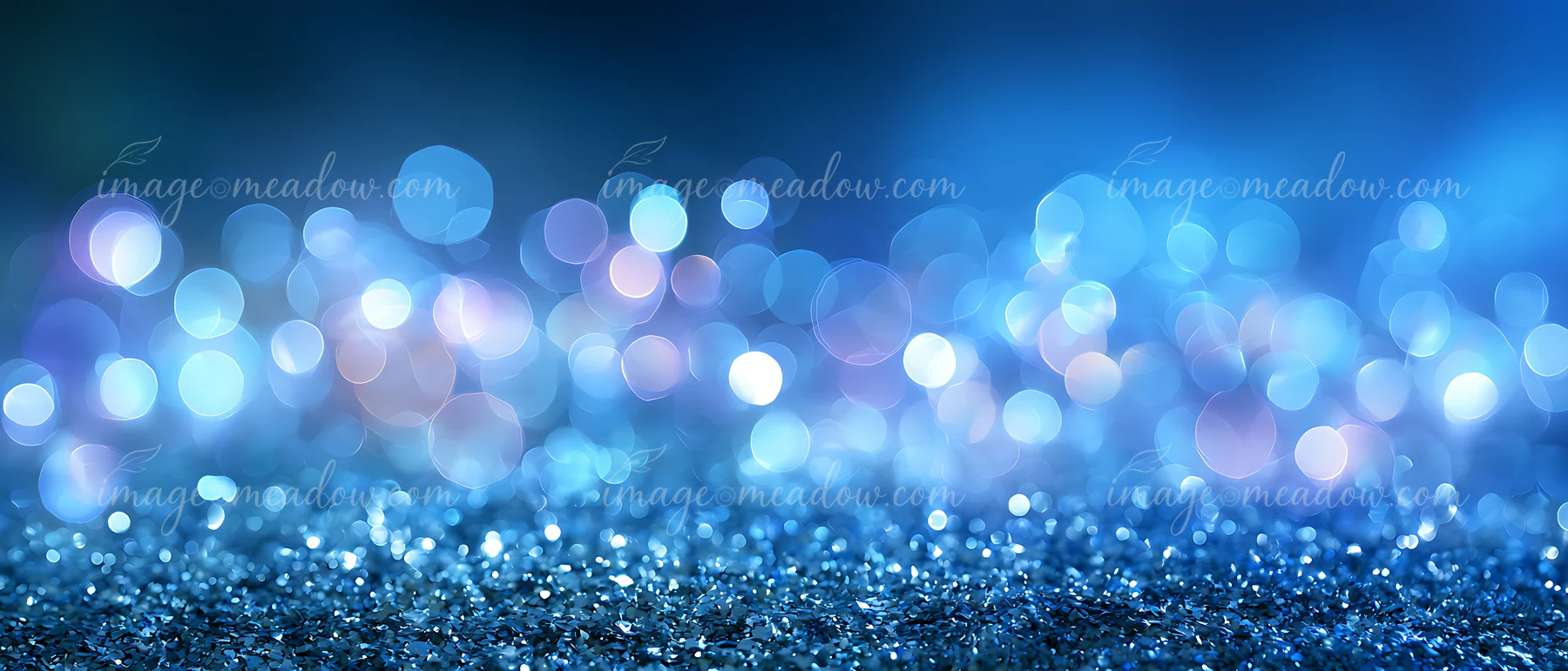 Blue backdrop features out-of-focus bokeh lights that create a shimmering effect.