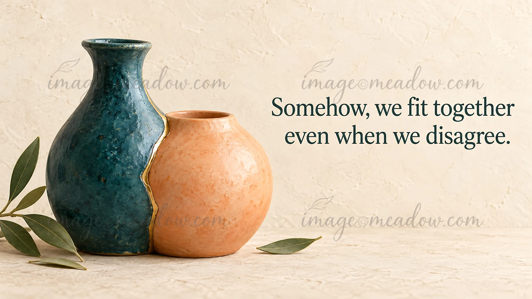 Two contrasting ceramic vases touch along a gold-edged seam beside olive leaves on a warm, textured background. The greeting reads, “Somehow, we fit together ev