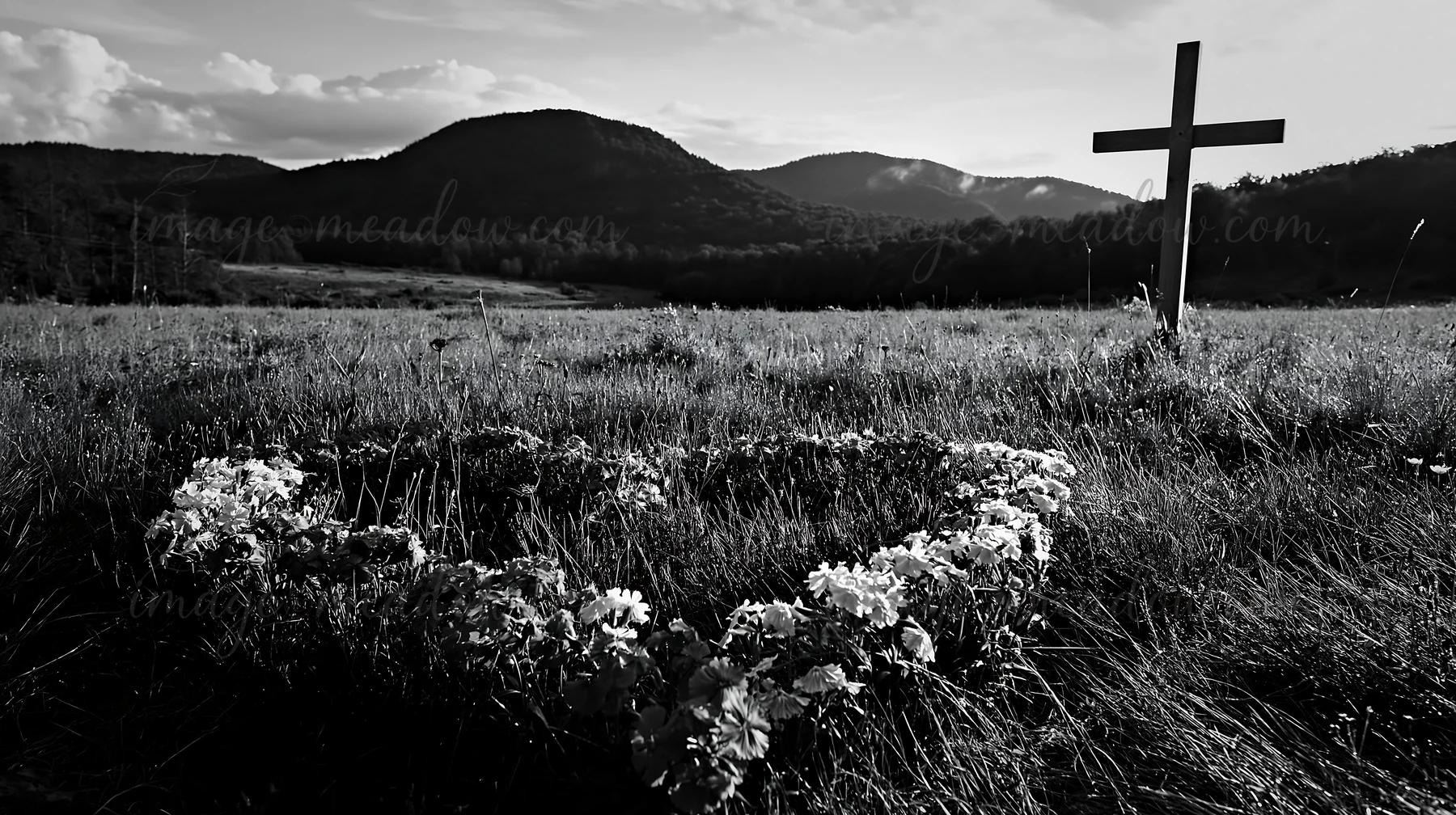 A wooden cross stands in a meadow surrounded by grass and flowers. The scene features mountains in the background under a cloudy sky. It represents a connection