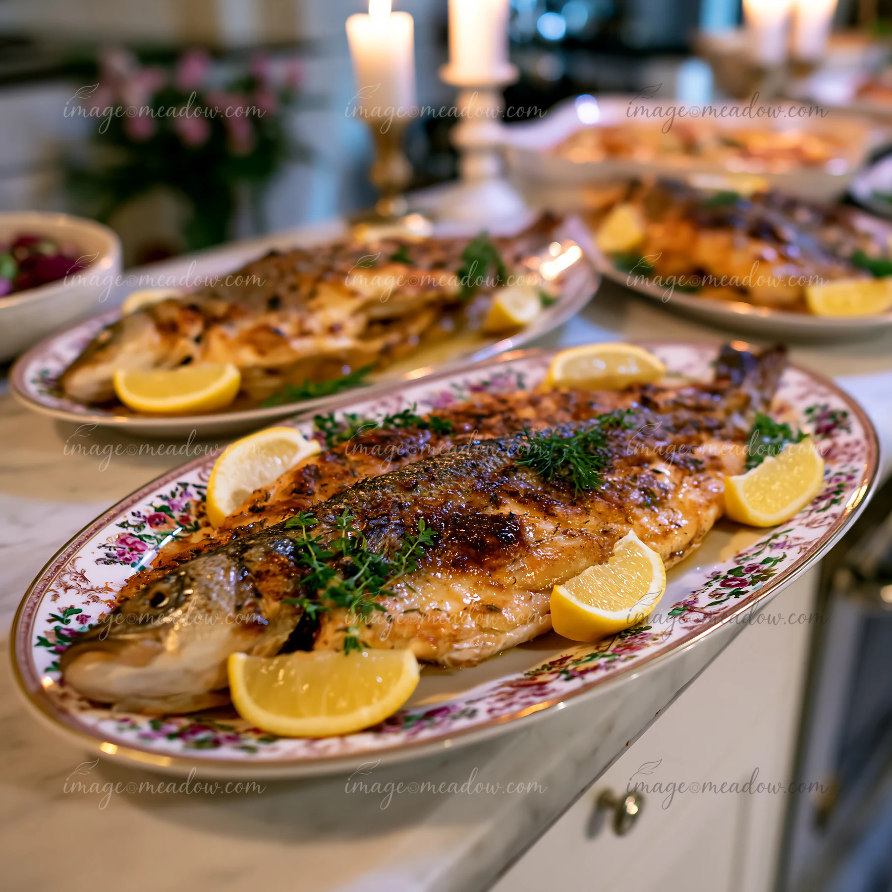 Colorful festive serving platters display grilled fish garnished with lemon slices in a bright kitchen.