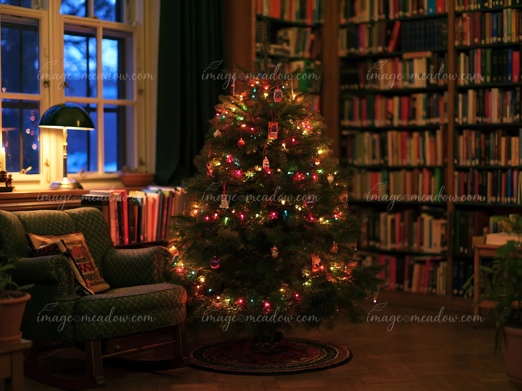 Decorated Christmas tree glowing beside an armchair and bookshelves in a warmly lit library.