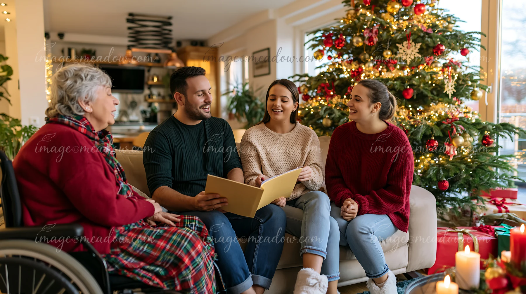 Four family members sing from a songbook indoors beside a decorated Christmas tree.