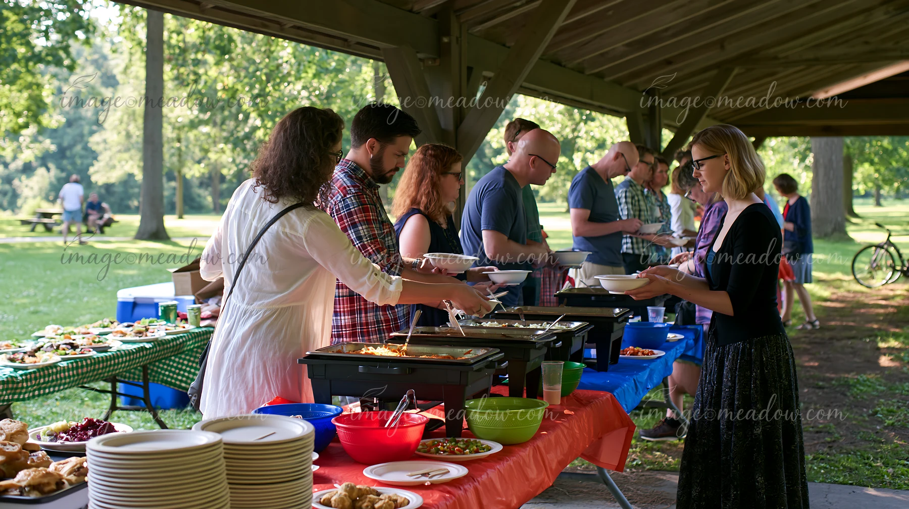People enjoy a church gathering buffet at a park.