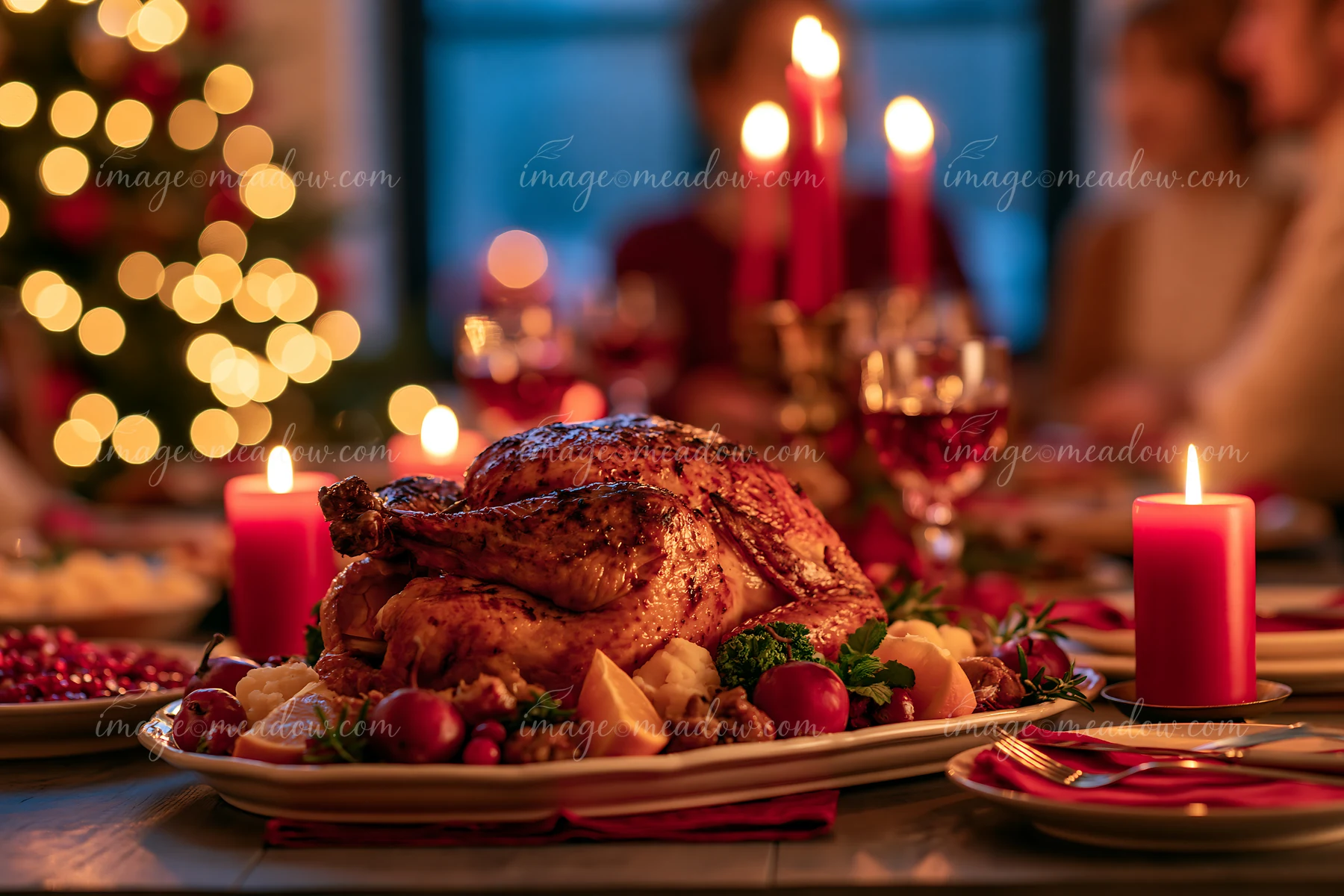 Roasted turkey sits on a festive dining table with garnishes, red candles, glassware, and warm holiday lights.