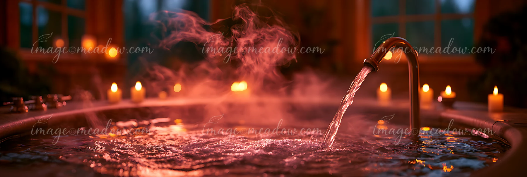 Steam rises from a hot tub filled with water, illuminated by soft candlelight.