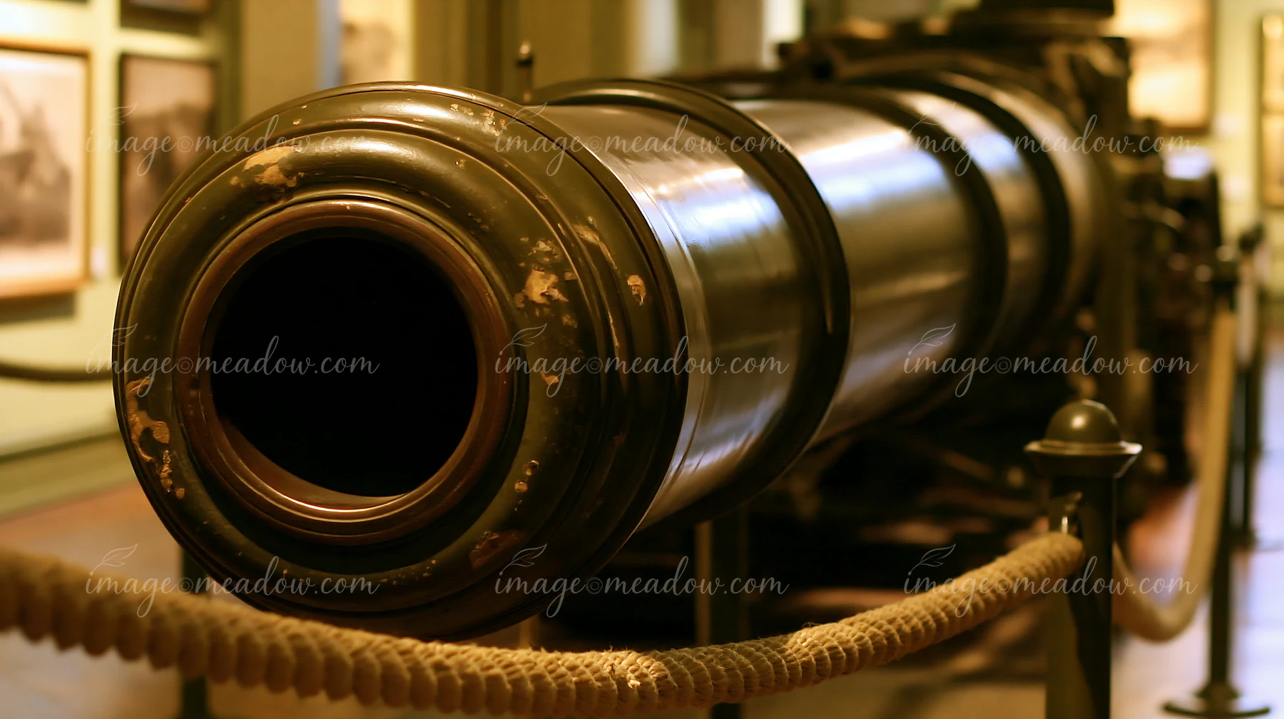 The panzer tank gun barrel detail shows the smooth surface and metallic finish in a museum setting.