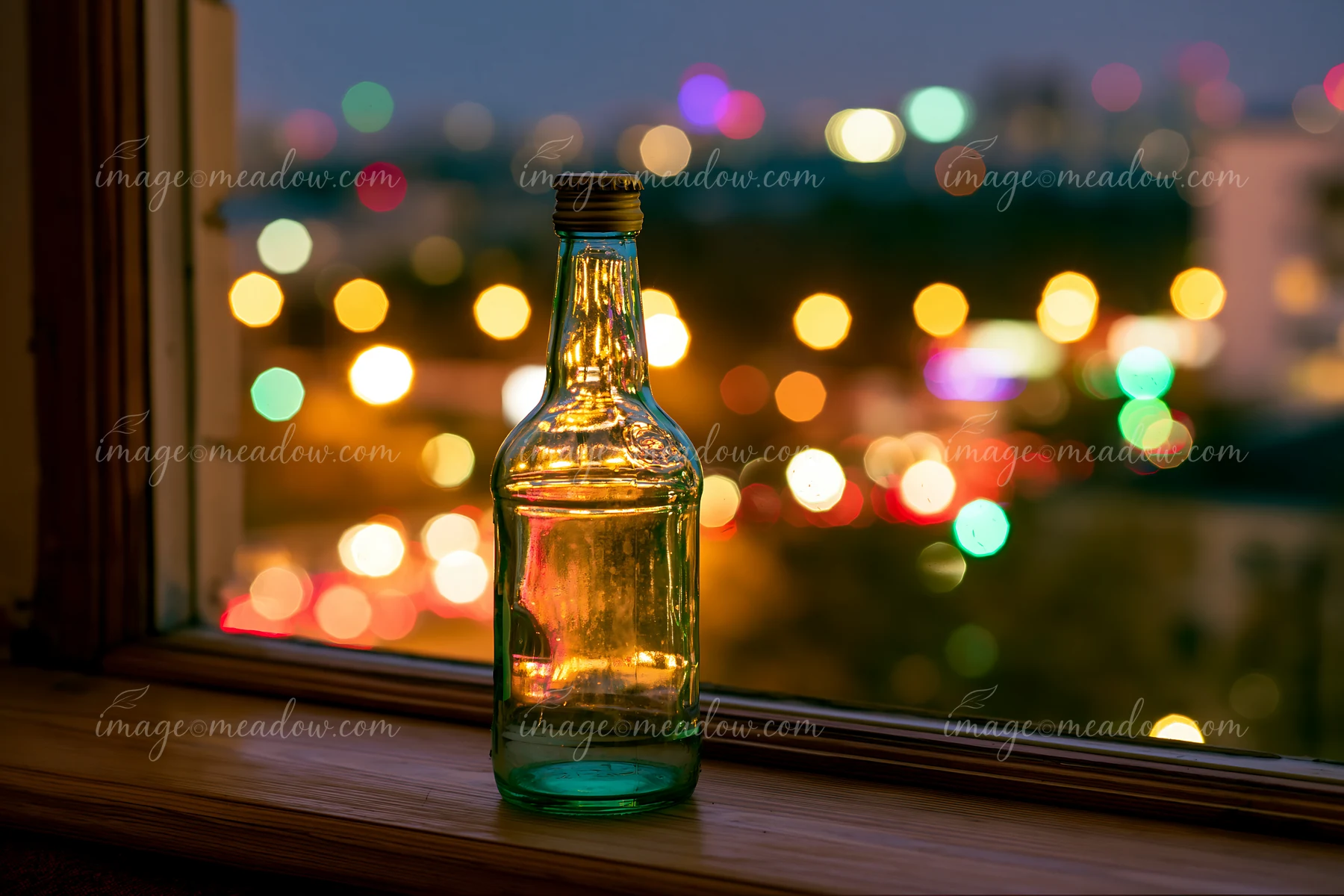 The scene shows an empty bottle after party placed on a windowsill.