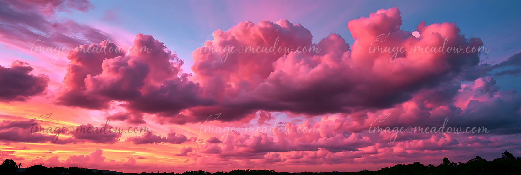 The sky displays pink and purple clouds at sunset over a landscape.